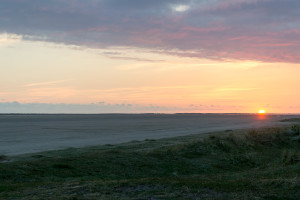 Blick über den Strand zur verschwindenen Sonne