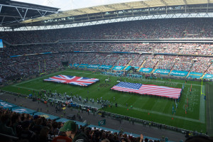 Bereit für die Nationalhymne mit großen Flaggen von USA und UK auf dem Spielfeld